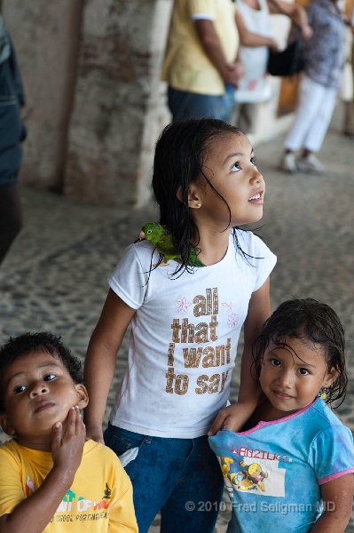 20101204_115730 D3 (1).jpg - Young girl protecting her younger siblings as they wait out a cloudburst